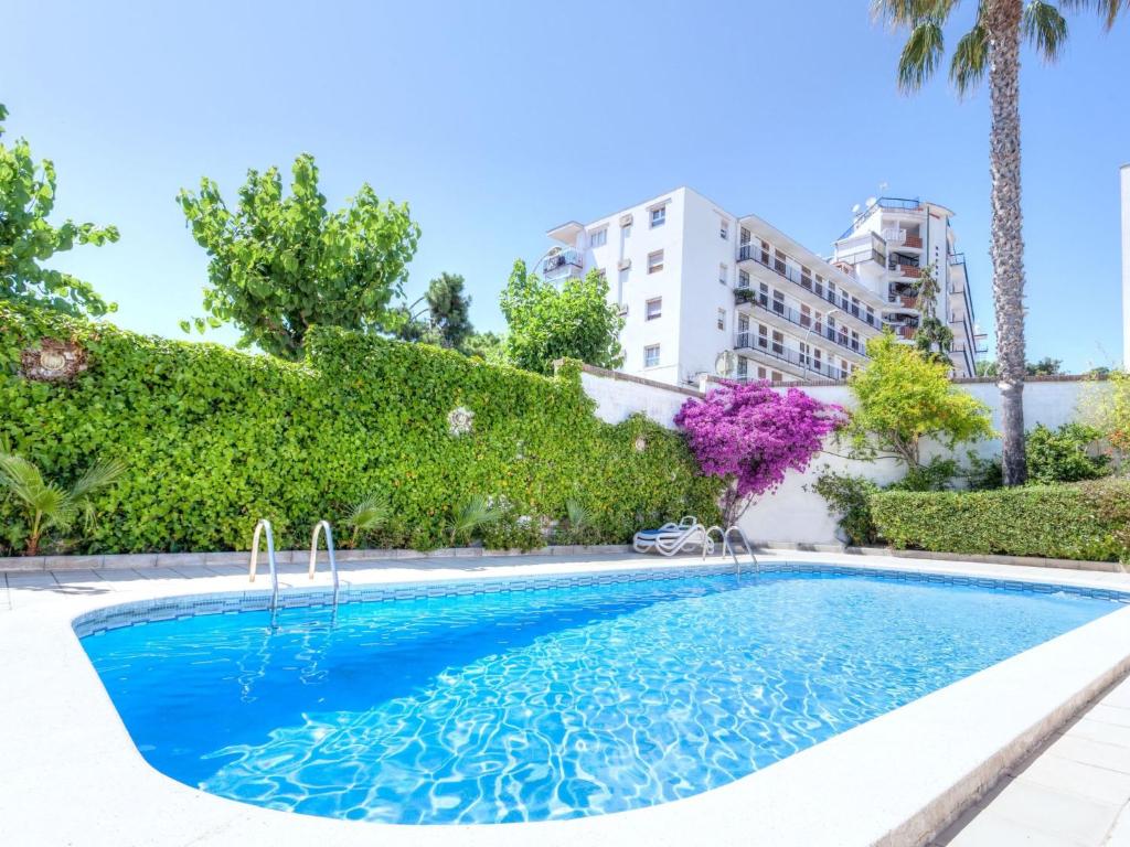 a swimming pool in front of a building at Apartment Fleming by Interhome in Lloret de Mar