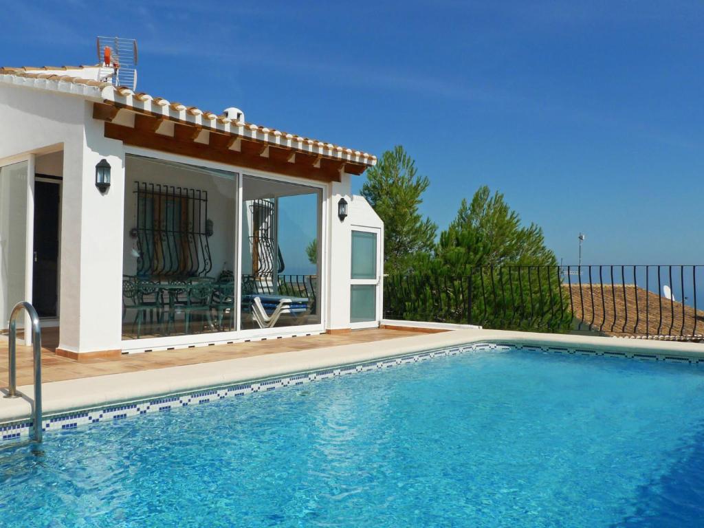 a swimming pool in front of a house at Holiday Home Gabi by Interhome in Monte Pego