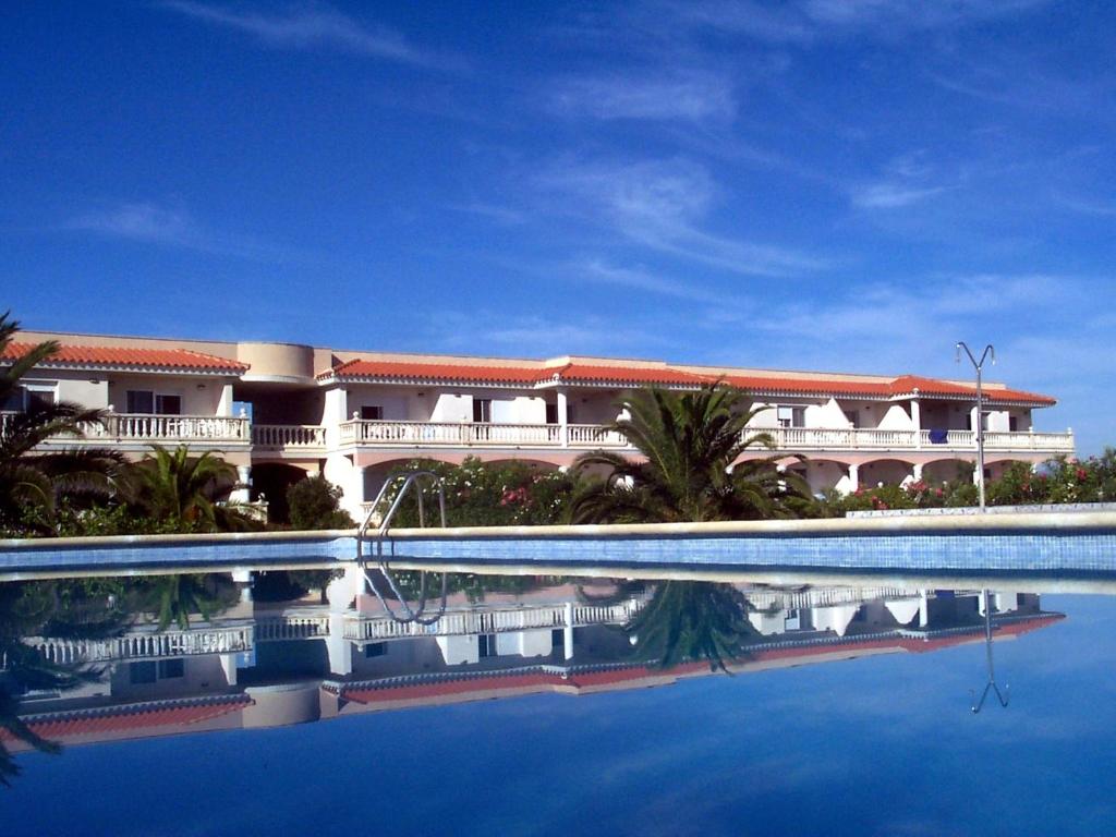 a large building with a swimming pool in front of it at Apartment Royal Delta-2 by Interhome in Riumar