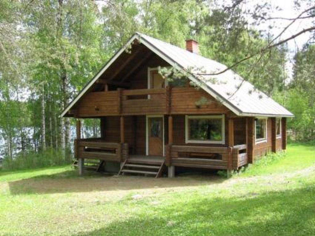 a small wooden cabin in the middle of a field at Holiday Home Pellervo by Interhome in Kurkimaki