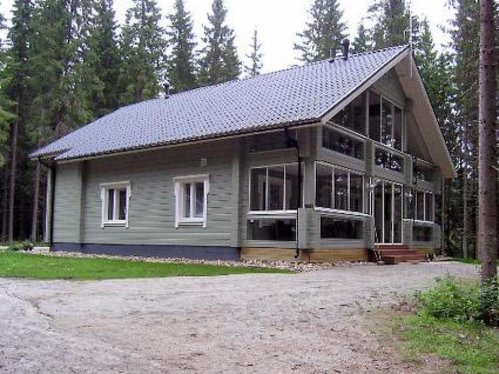 a large house with a lot of windows at Holiday Home Kärkelä by Interhome in Sulkava