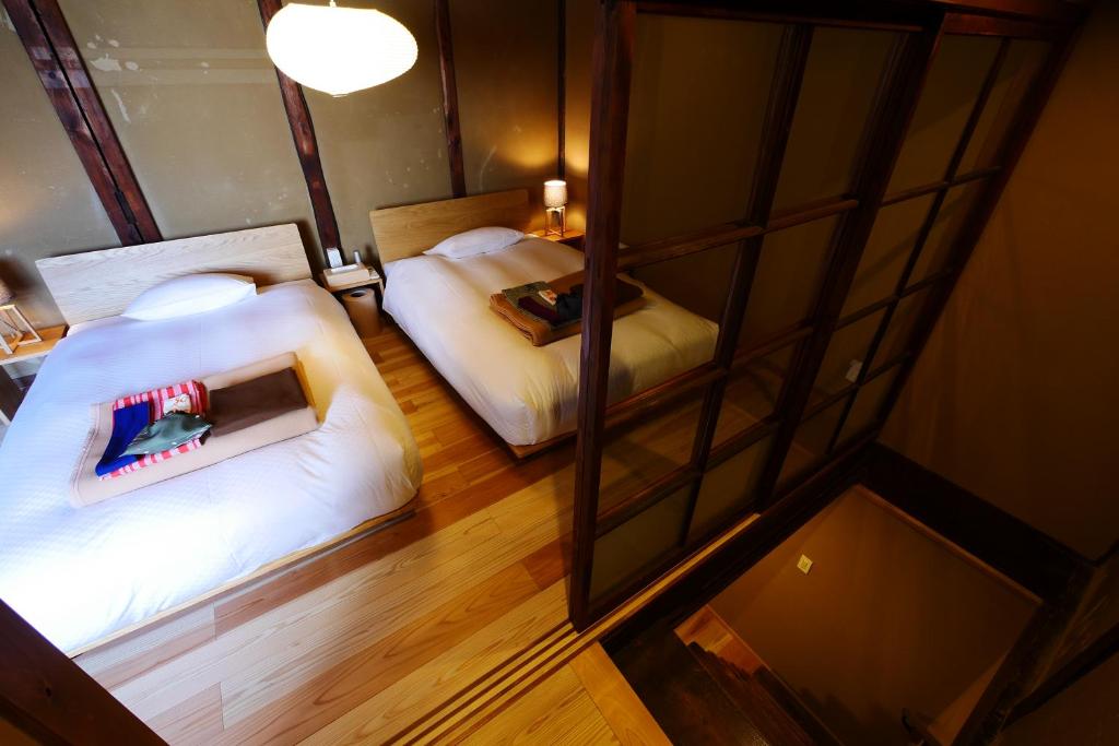 Postel nebo postele na pokoji v ubytování NIPPONIA HOTEL NARA NARAMACHI
