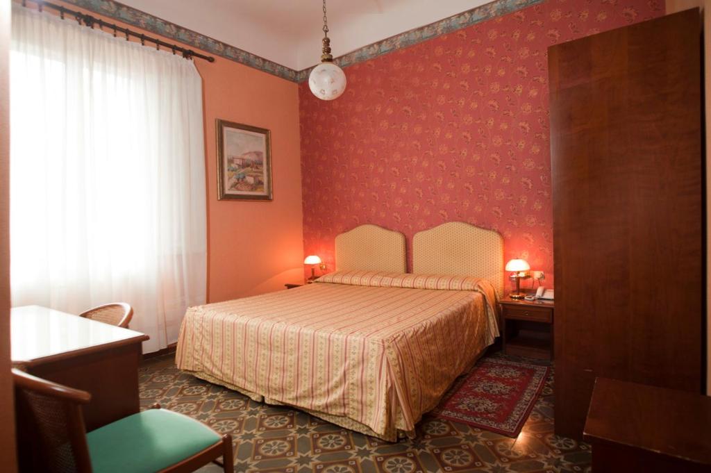 Postel nebo postele na pokoji v ubytování Hotel Beatrice