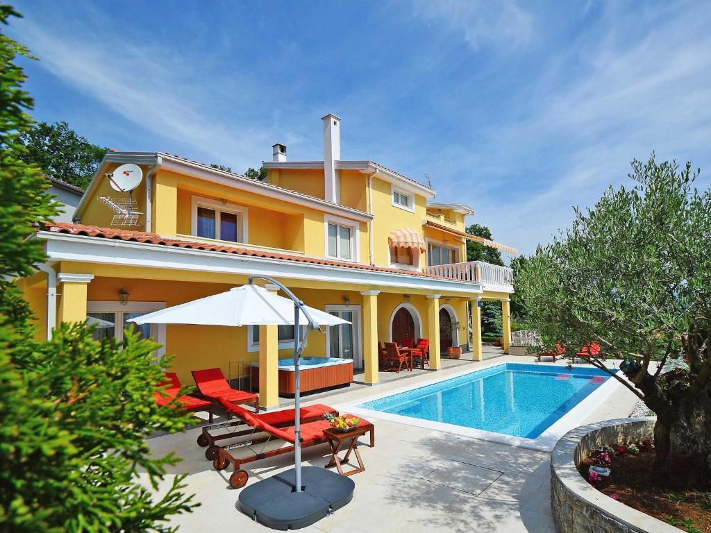 a villa with a swimming pool and a house at Holiday Home Villa Olea by Interhome in Opatija