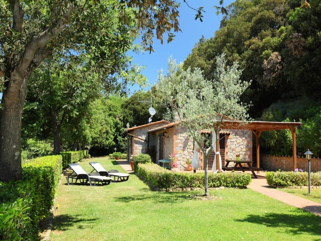 a garden with benches and a pavilion in a park at Holiday Home Poggiolo by Interhome in Roccastrada