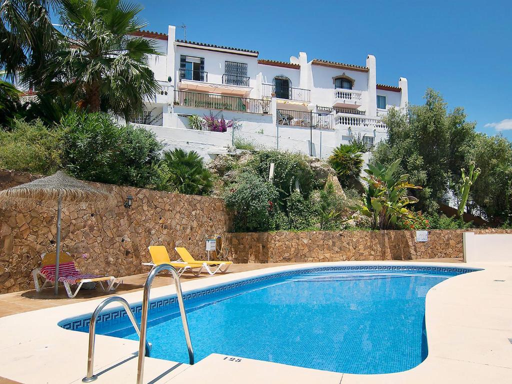 a swimming pool in front of a building at Holiday Home Amanda by Interhome in Nerja
