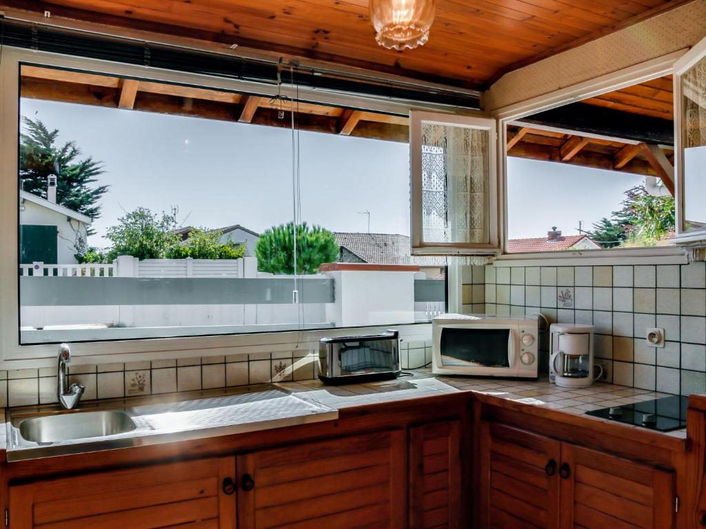 a kitchen with a sink and a microwave at Holiday Home Remember by Interhome in Mimizan-Plage