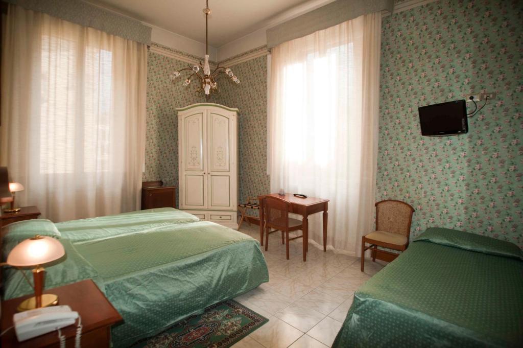 Postel nebo postele na pokoji v ubytování Hotel Beatrice