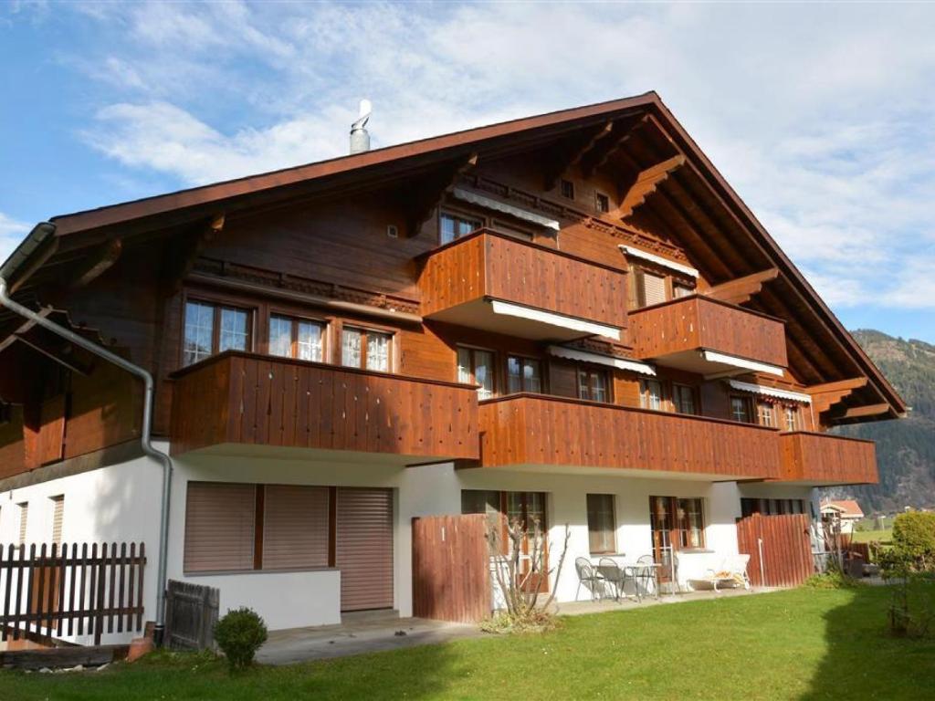 a large house with a gambrel roof at Apartment Simmental by Interhome in Zweisimmen