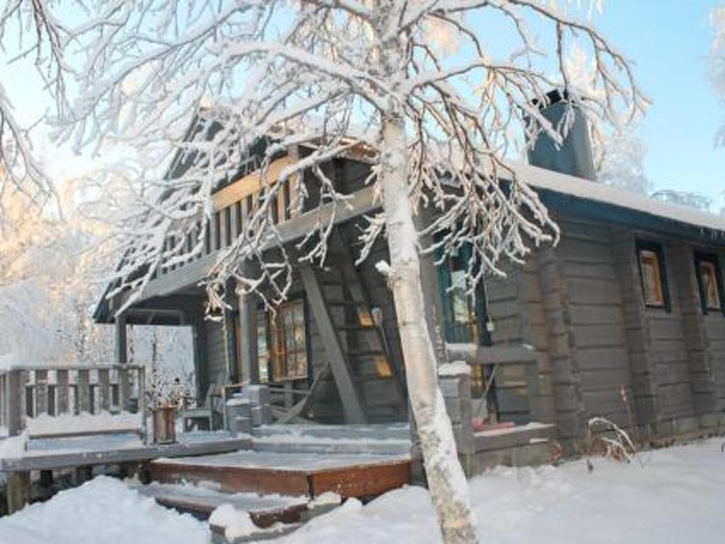 a log cabin with snow on the branches of a tree at Holiday Home Juolukka by Interhome in Pulju