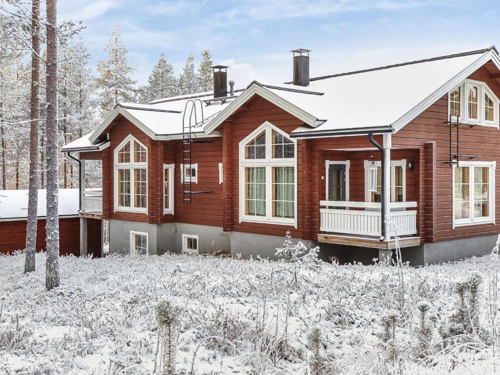 a wooden house in the snow at Holiday Home Poronpurema a by Interhome in Levi