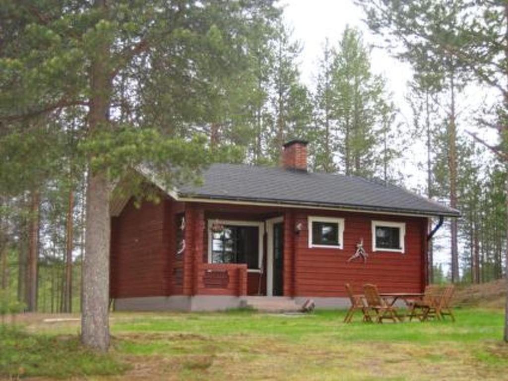 a small red cabin in the middle of a forest at Holiday Home Takaharju by Interhome in Karvonen