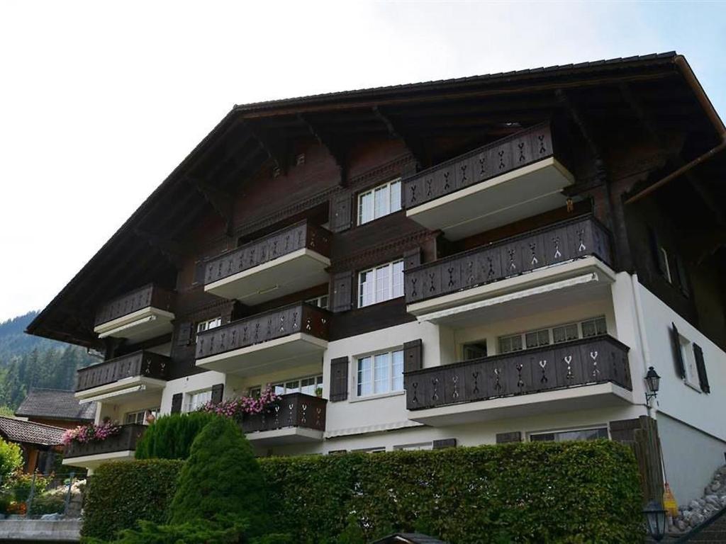 a building with balconies on the side of it at Apartment Fink by Interhome in Zweisimmen