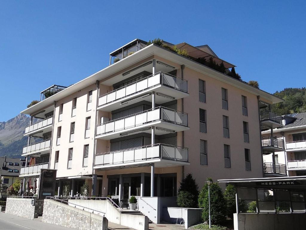 a large white building with balconies on a street at Apartment Hess Park by Interhome in Engelberg