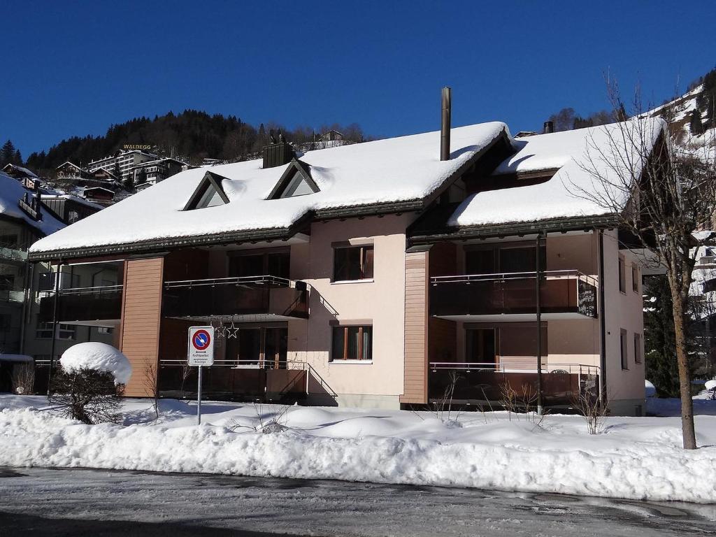 a building with snow on top of it at Apartment Blumenweg 2 by Interhome in Engelberg