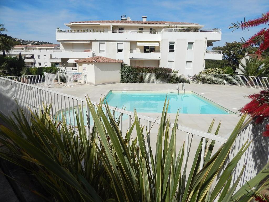 a swimming pool in front of a building at Apartment Cap Marine-2 by Interhome in Cavalaire-sur-Mer