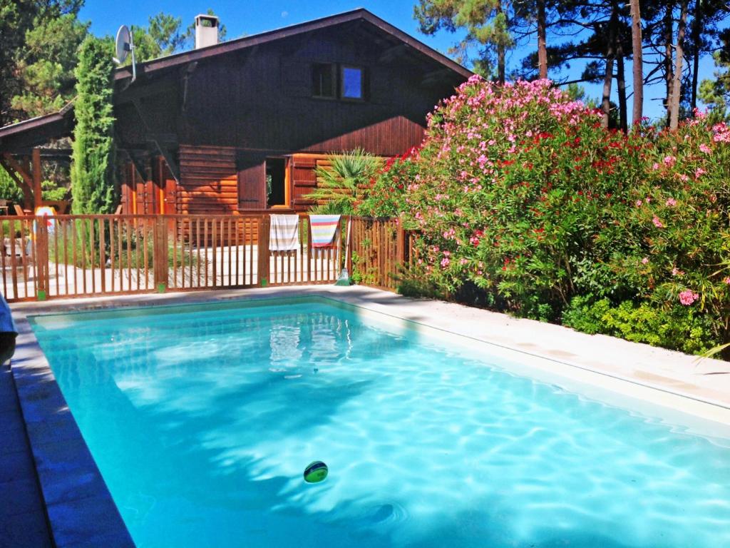 a swimming pool in front of a house at Holiday Home Lac et Forêt by Interhome in Le Moutchic