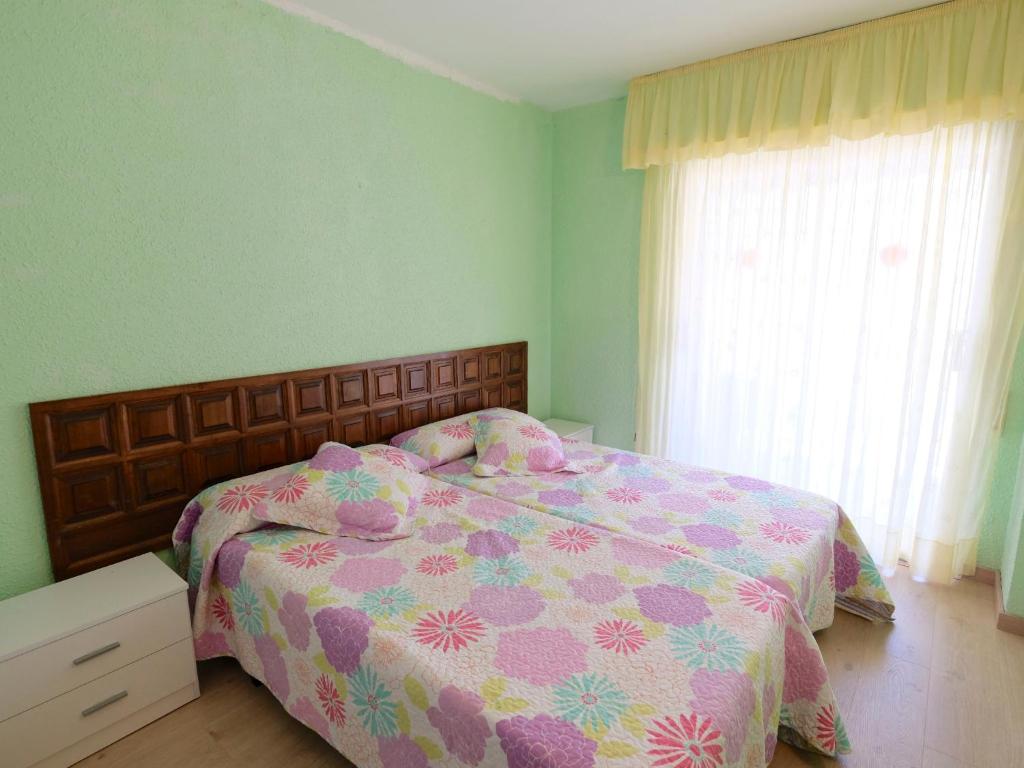 A bed or beds in a room at Apartment DMS IV-3 by Interhome