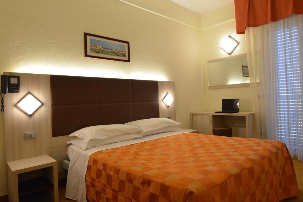 Postel nebo postele na pokoji v ubytování Hotel Doge