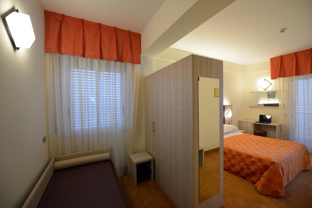 Postel nebo postele na pokoji v ubytování Hotel Doge