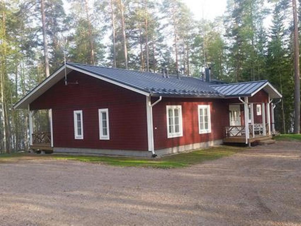 a small red house in the middle of a forest at Holiday Home Ylä-hannala by Interhome in Muurame