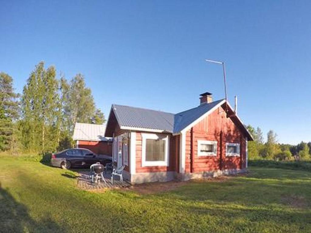 a small house with a car parked in front of it at Holiday Home Pikku-villa by Interhome in Vähäsalmi
