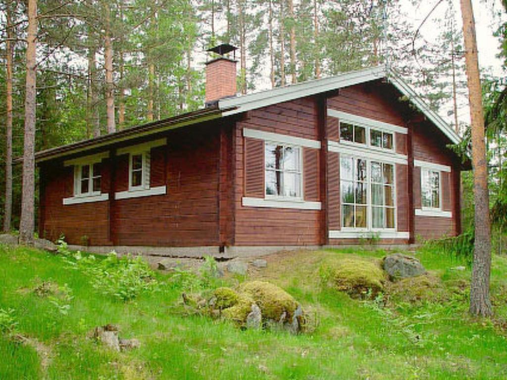 a small wooden house in the middle of a field at Holiday Home Ylähuone by Interhome in Pätiälä