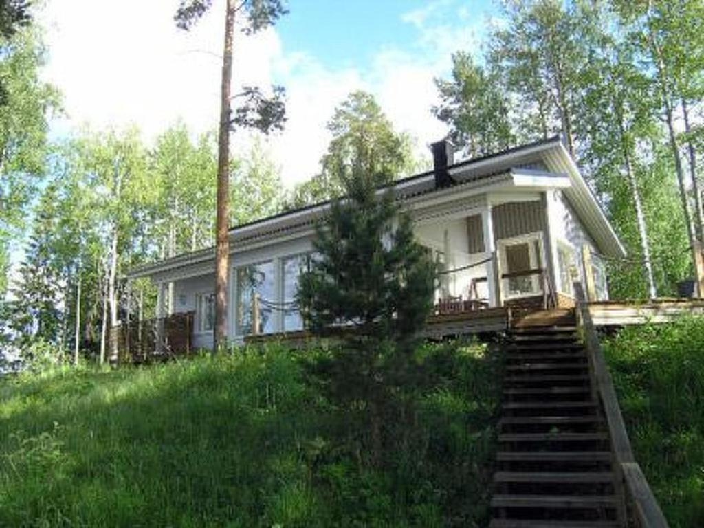 a small house in the middle of a field at Holiday Home Harjunniemi by Interhome in Vilppula