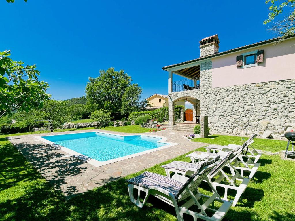 a villa with a swimming pool in a yard at Holiday Home Panorama 2 by Interhome in Labin
