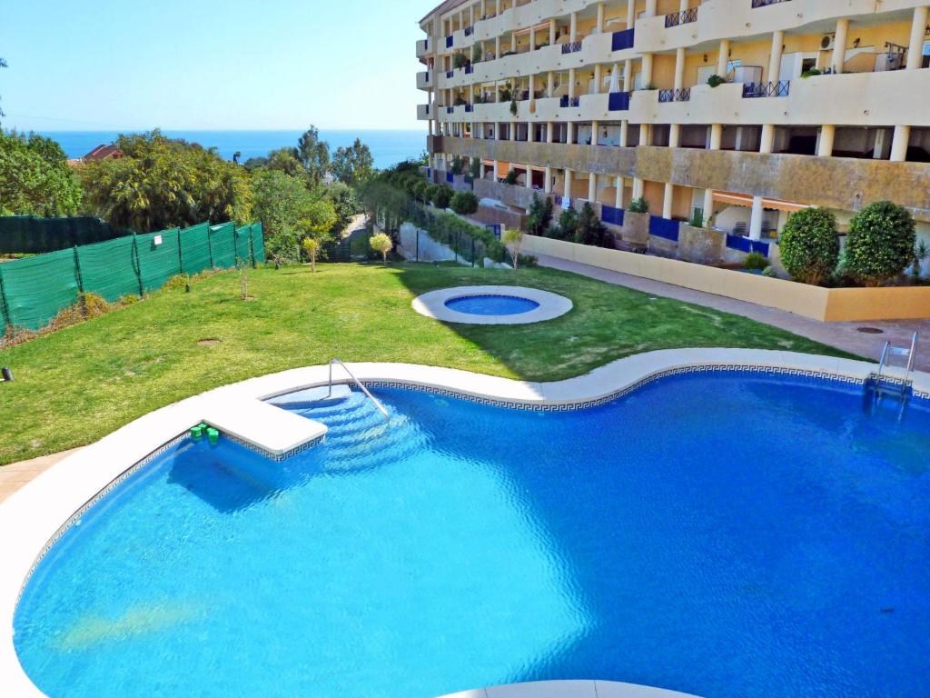 a large swimming pool in front of a building at Apartment Torrealba by Interhome in Fuengirola