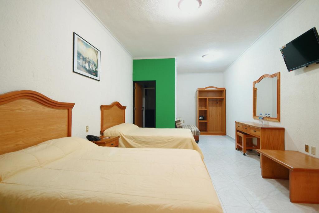 Postel nebo postele na pokoji v ubytování HOTEL EL CONQUISTADOR MONARCA.
