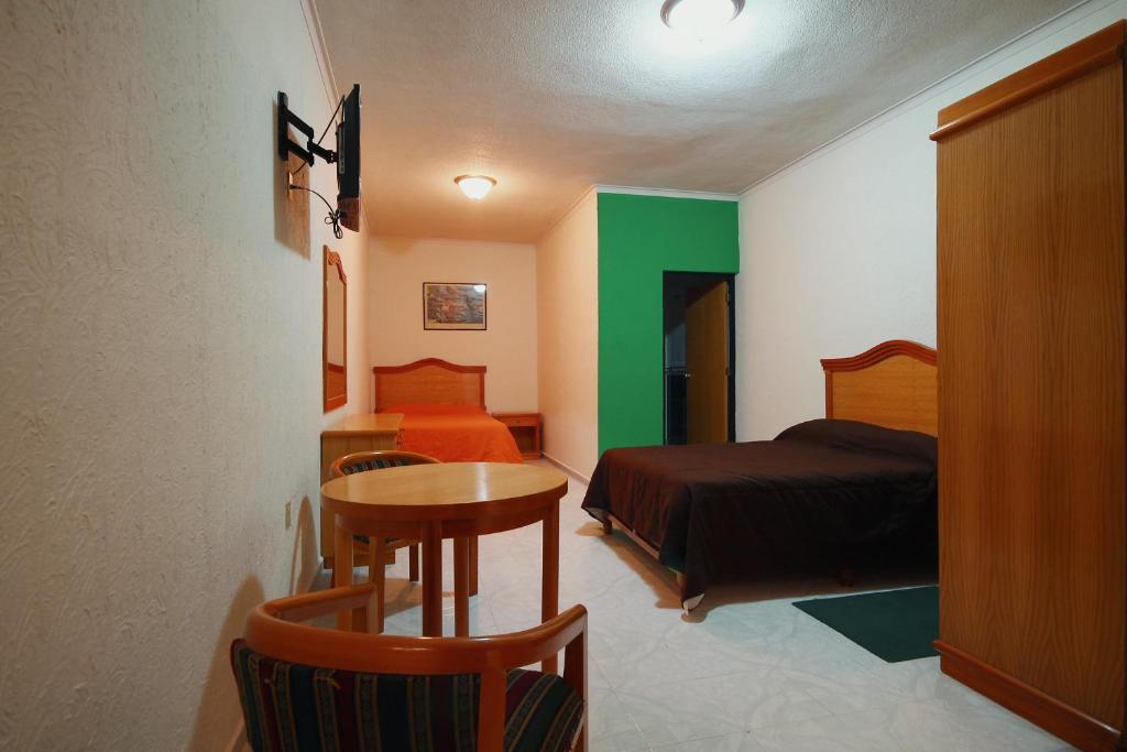 Postel nebo postele na pokoji v ubytování HOTEL EL CONQUISTADOR MONARCA.