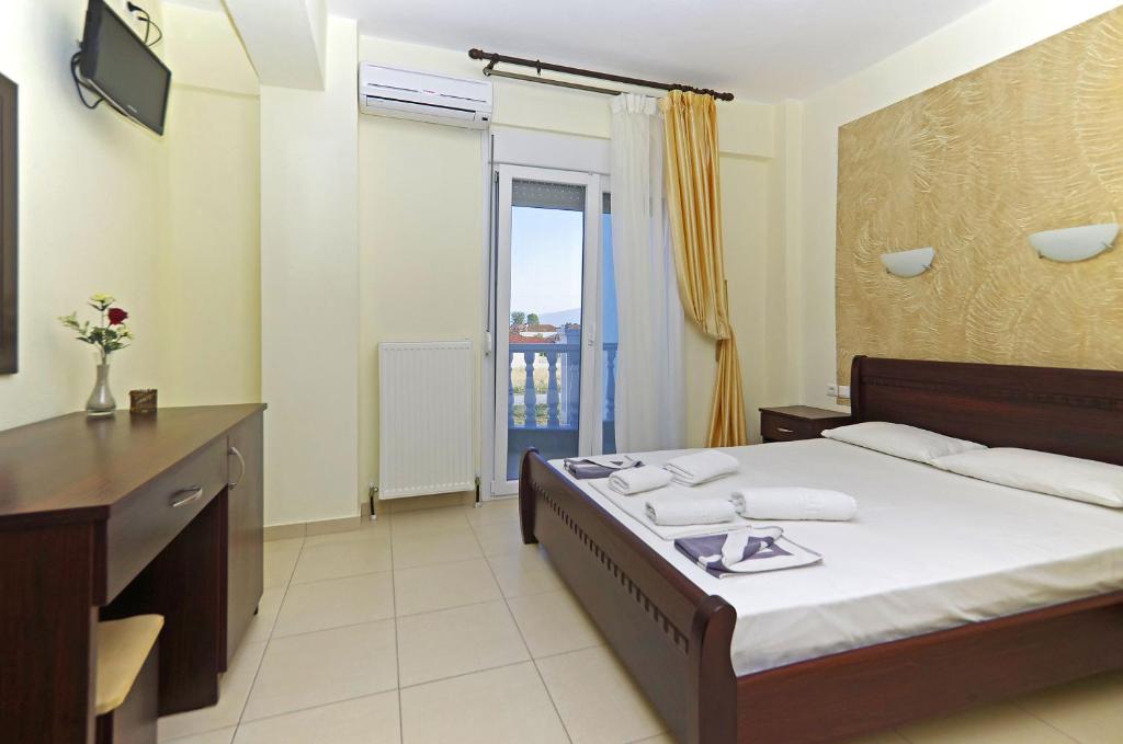 pokój hotelowy z łóżkiem i balkonem w obiekcie Hotel Paris w Paralii Katerinis