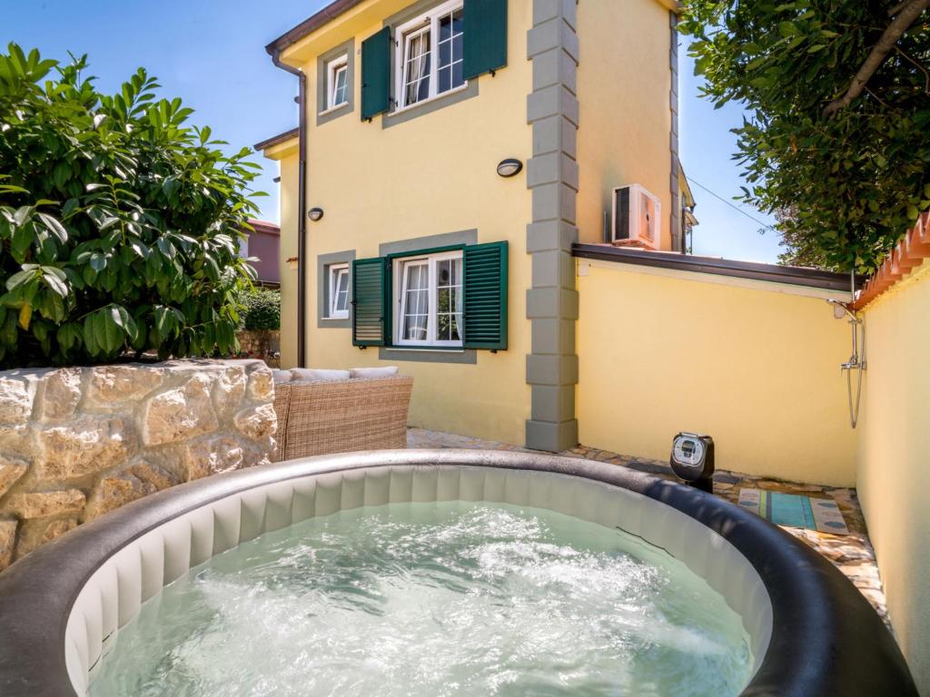 a hot tub in the backyard of a house at Holiday Home Zora by Interhome in Njivice