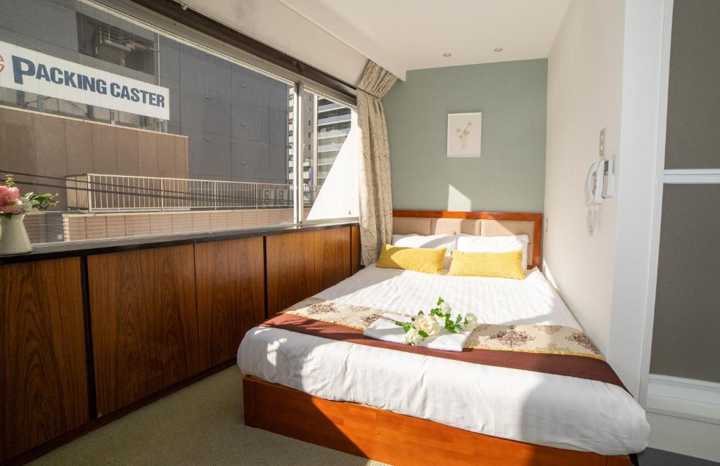 Postel nebo postele na pokoji v ubytování Tabata Oji Hotel