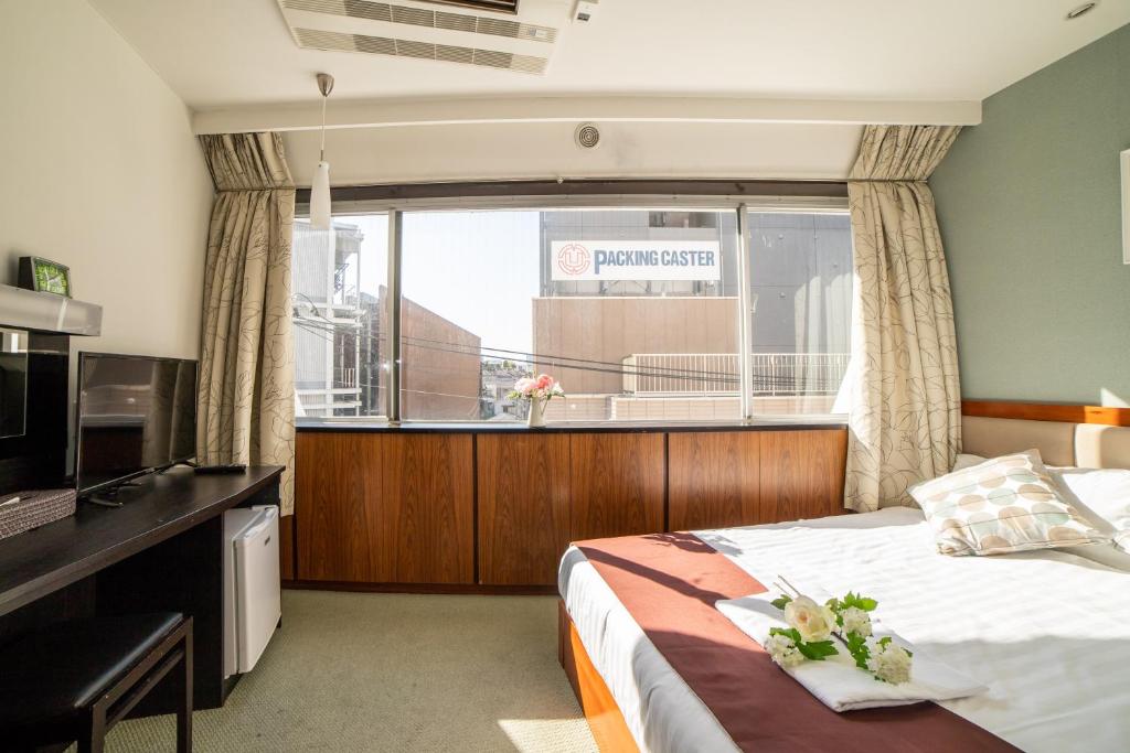 Postel nebo postele na pokoji v ubytování Tabata Oji Hotel