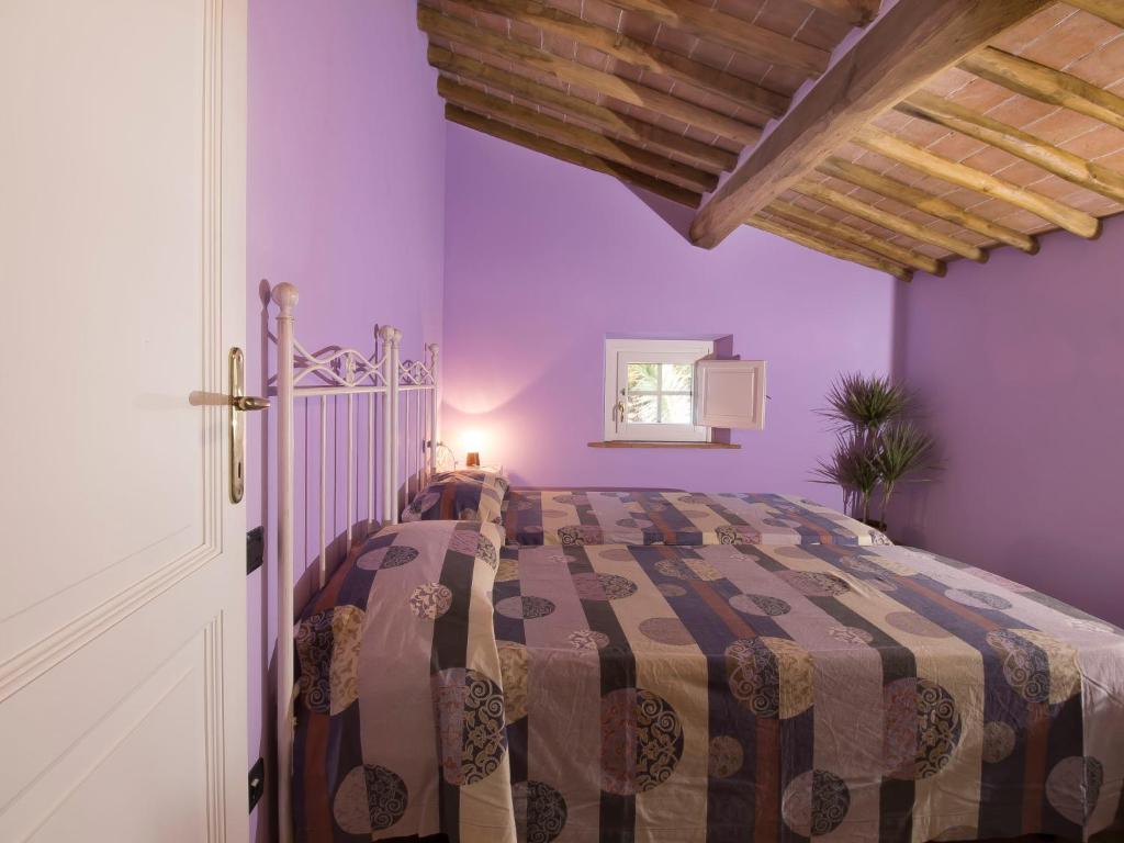 A bed or beds in a room at Holiday Home Villa il Pellicano by Interhome
