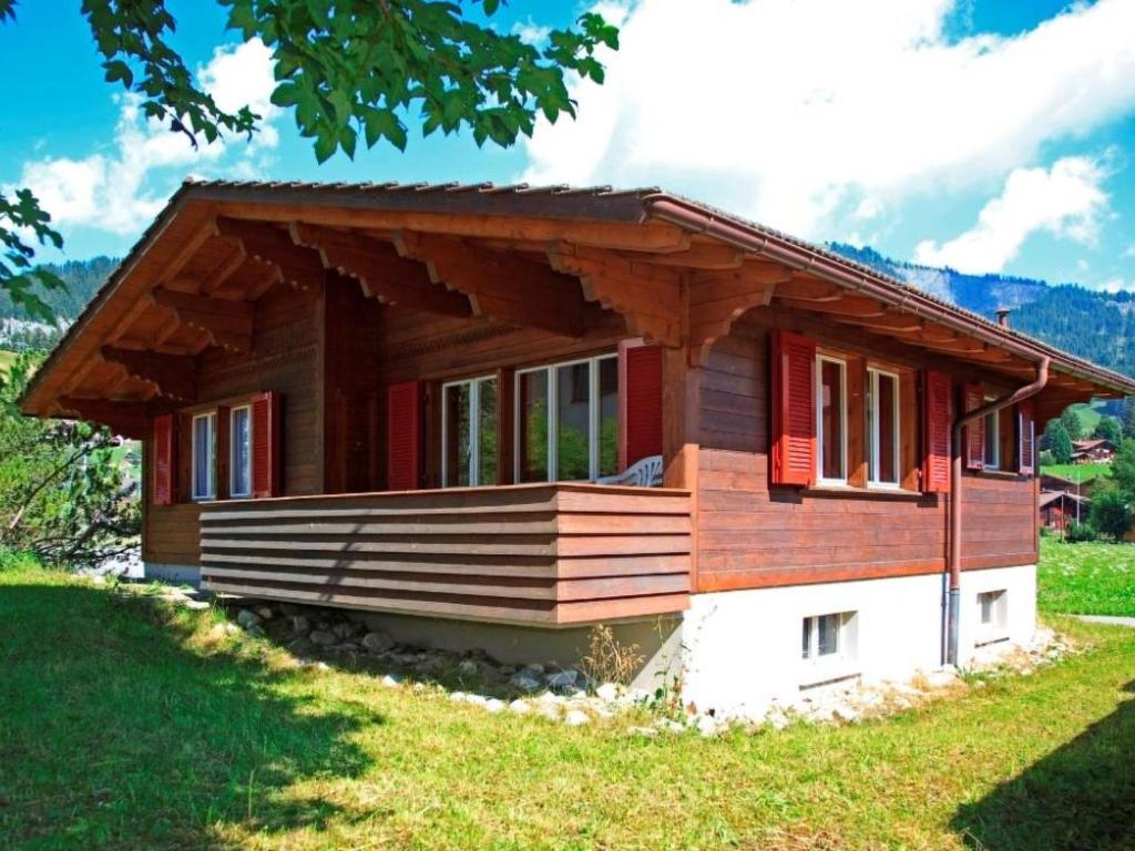 a small wooden house in a field of grass at Apartment Bodehus by Interhome in Adelboden