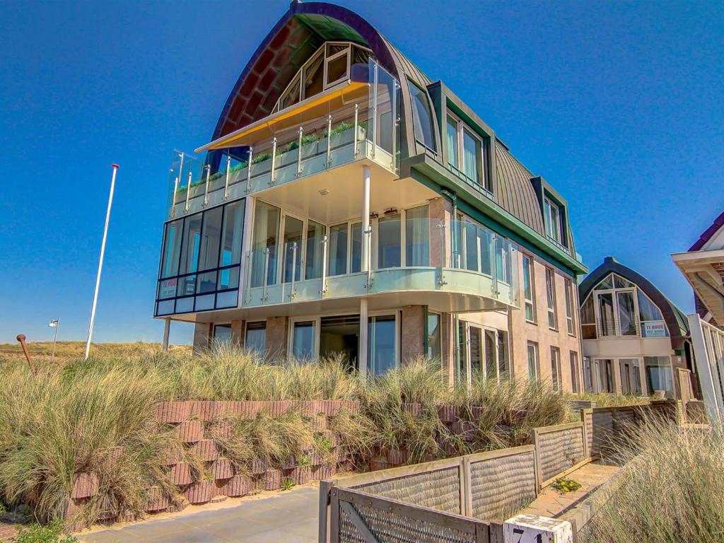 a large building on top of a beach at Apartment De Zeeparel by Interhome in Egmond aan Zee