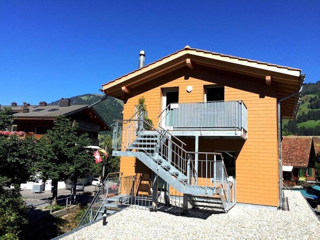 a building with a staircase on the side of it at Apartment Simme-Tröimli by Interhome in Zweisimmen