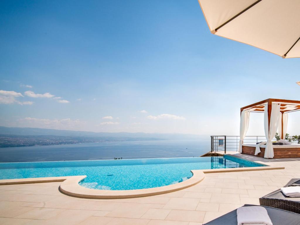 a swimming pool with a view of the water at Villa Marone by Interhome in Dobreć