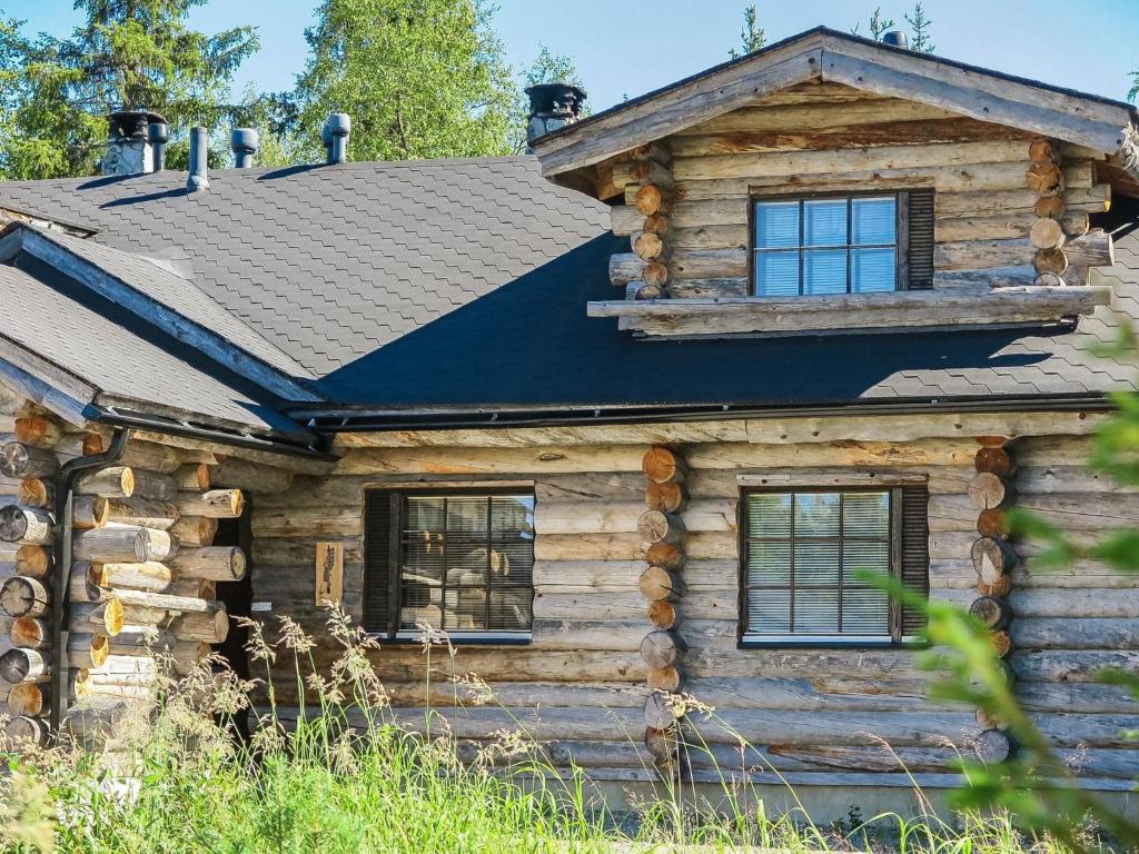 a log cabin with a black roof at Holiday Home Kantapää d2 by Interhome in Luosto