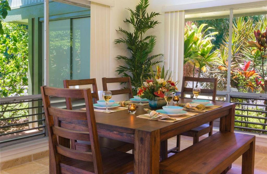 a wooden dining room table with chairs and a table and chairsktop at Puamana 4D Golf Courses Condo in Princeville