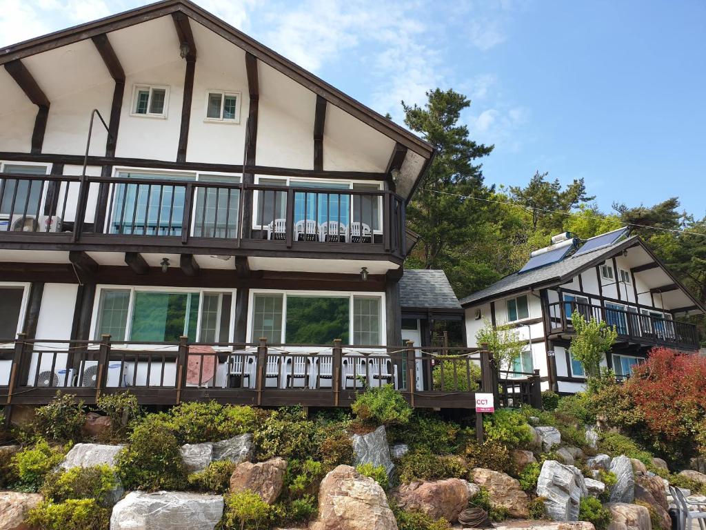 a large house with a garden in front of it at Tongyeong Yehyang Pension in Tongyeong