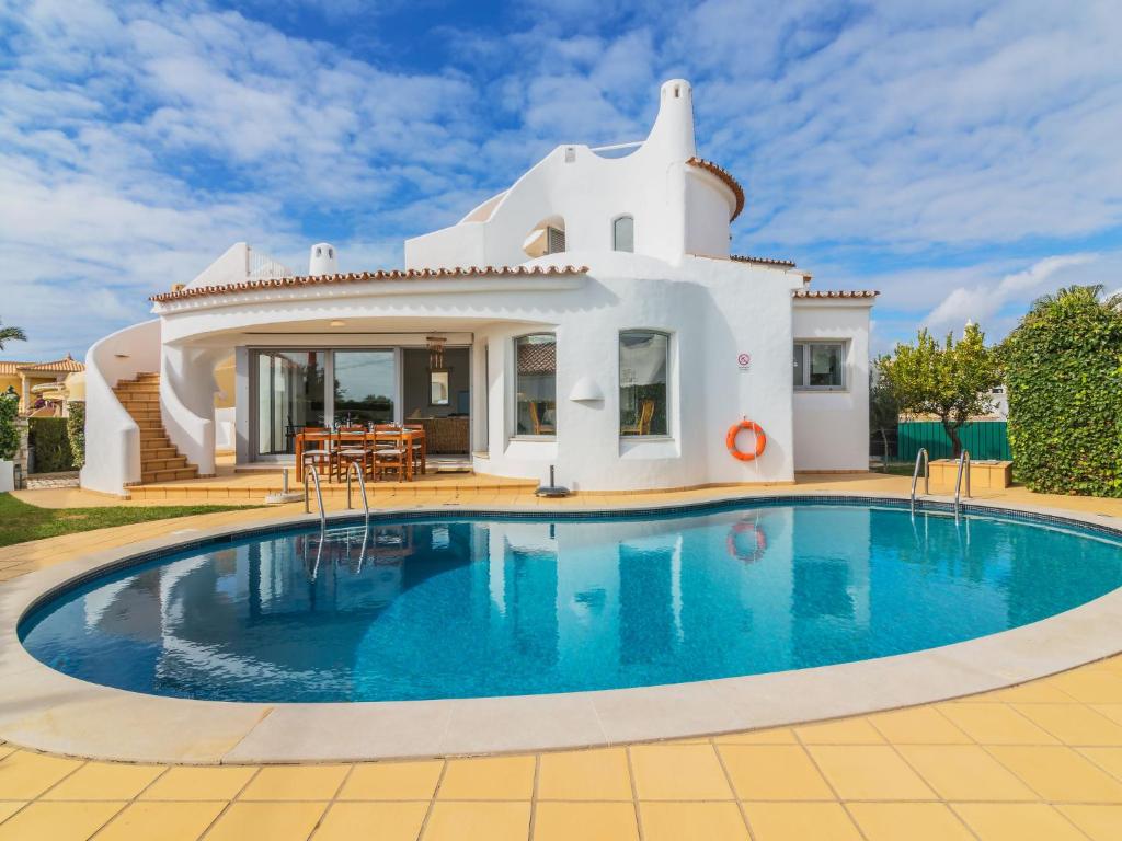 a villa with a swimming pool in front of a house at Villa Arribas Villa by Interhome in Patroves