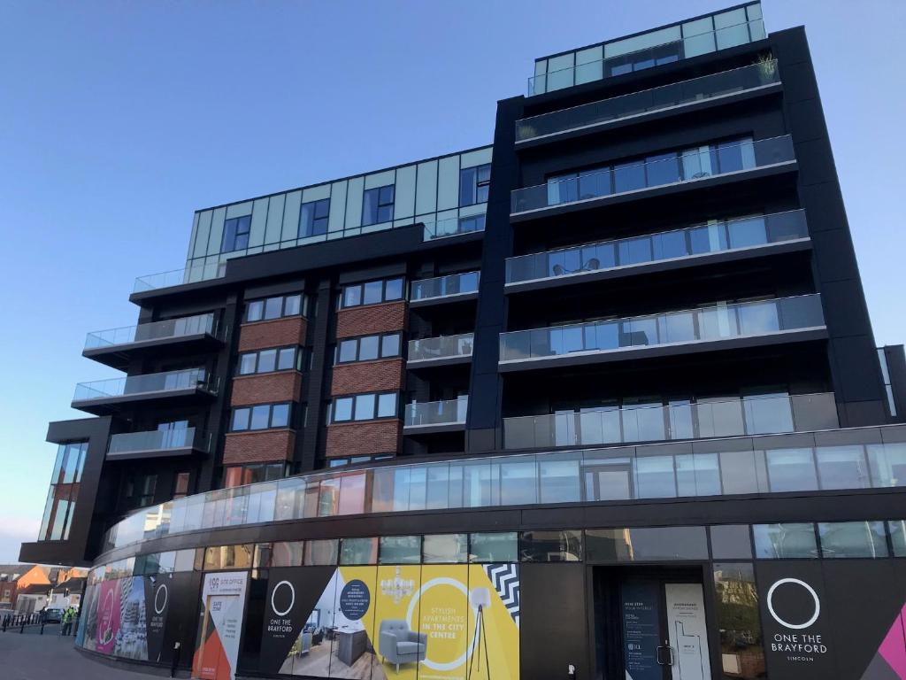 a tall black building with a lot of windows at Birchover One The Brayford in Lincoln