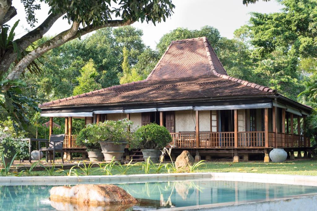 a house with a swimming pool in front of it at Kahanda Kanda in Koggala