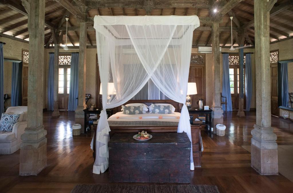 a bedroom with a bed with a canopy at Kahanda Kanda in Koggala