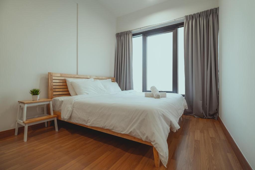 a bedroom with a large bed and a large window at Muji Home 1 - Sea and City View 2BR at 218 Tropicana NEAR Komtar FoodHeaven with Netflix & TV Box in George Town