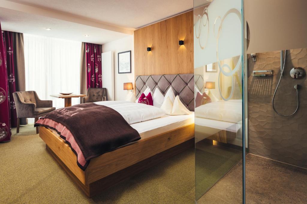 Postel nebo postele na pokoji v ubytování Hotel Garni Angela